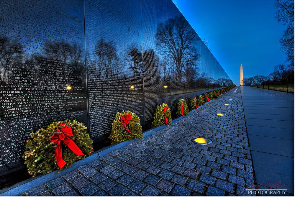 741291_507628989277119_1274867704_o A row of wreaths on the side of a wall.